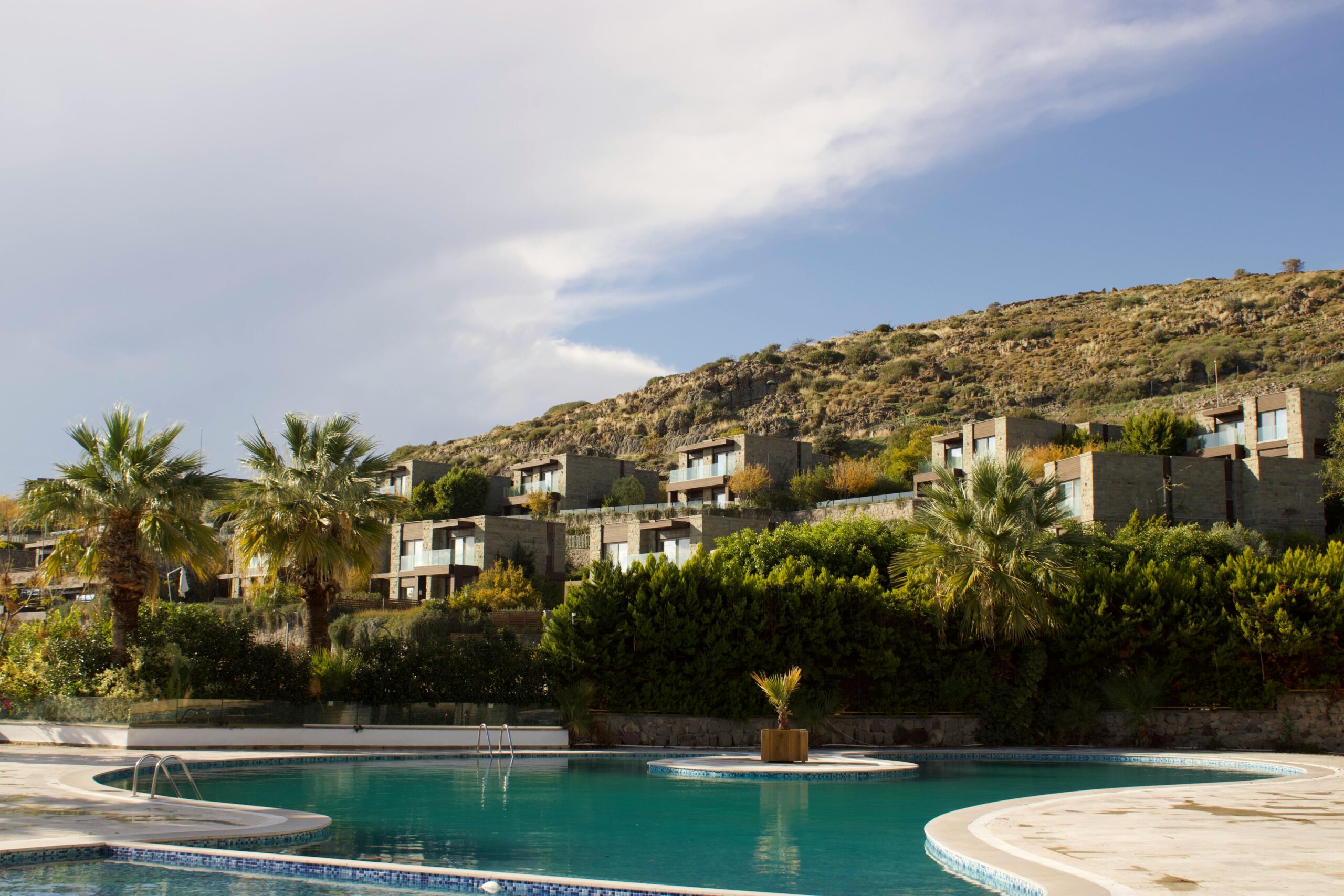 Overlooking a serene pool and lush landscape in Bodrum, Türkiye, perfect summer getaway.